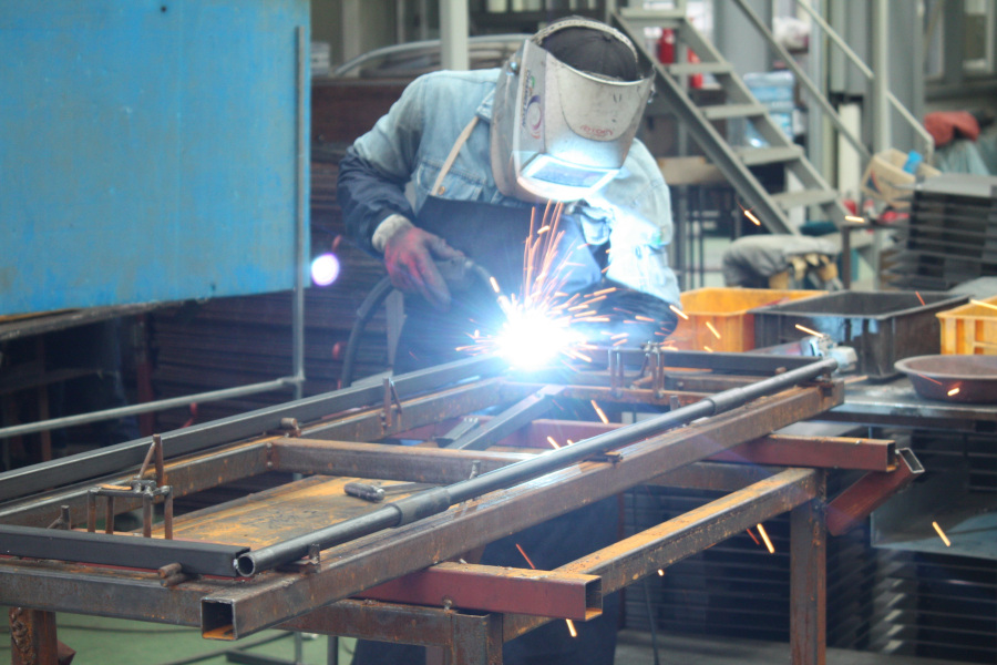 Welder working in the Florida Metal Solutions shop